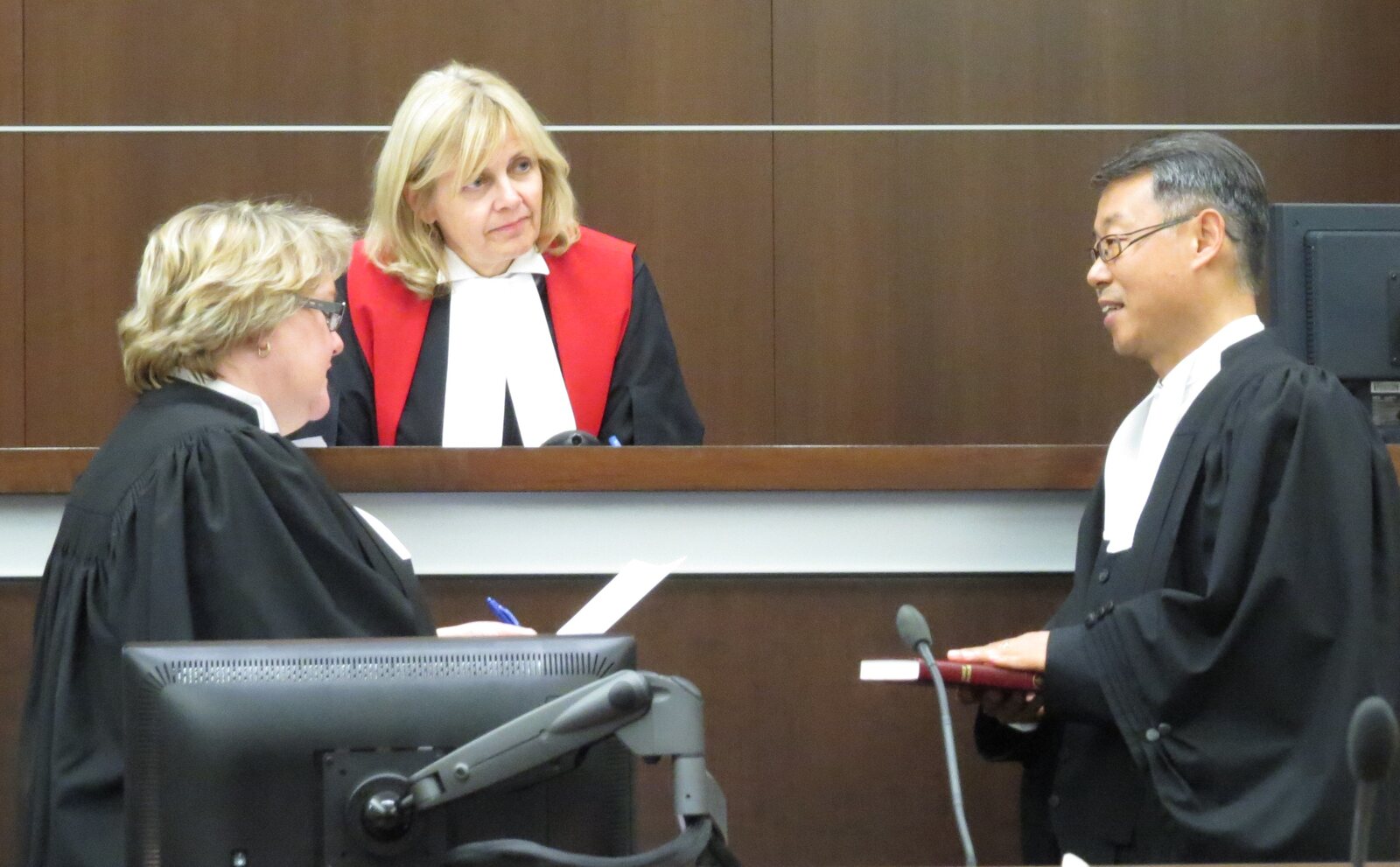 Yue (Roger) Song in barrister robes during a courtroom ceremony